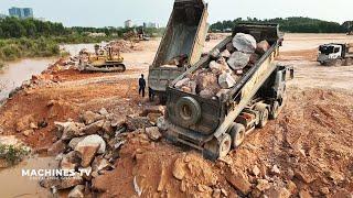 Huge Land Reclamation Process Dump Truck Management Unloading Rock Dirt Bulldozer Pushing Stone