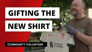 Gifting the new LFC away shirt to a community volunteer