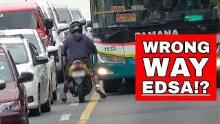 Rider drives against traffic inside the EDSA bus lane