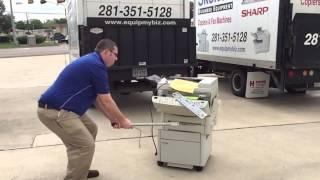 Darryl smashing an old copier @ Skelton Business Equipment