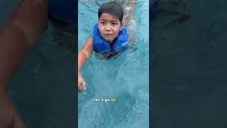 Son pushes mom in the pool after she tries to get him and dad out #shorts