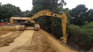 cat 336DL excavator trimming a batter