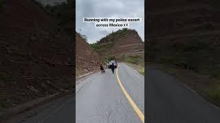 Running across Mexico with my police escort during my triathlon around the world 