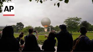 Hundreds line up in Paris' Tuileries to see the Olympic cauldron