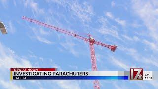 2 men charged after parachuting off crane in downtown Raleigh, police say