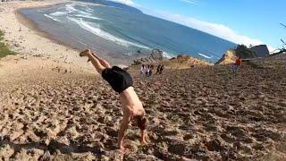 Man Backflips Down Steep Sand Bank