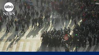 Riot police and protesters clash in Paris