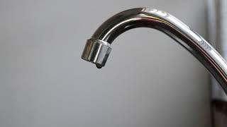 Free stock video background loop of close up dripping faucet