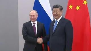 Presidents of Russia and China shake hands ahead of BRICS summit | AFP