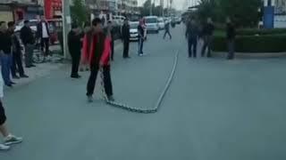 Guy whipping giant chain whip