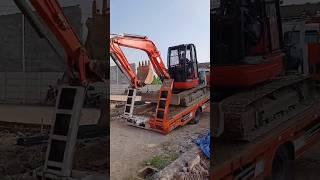 Mini Excavator Disembarks From Truck At Residential Location