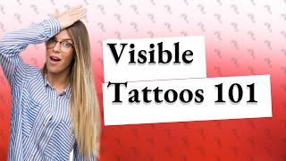 What is considered a visible tattoo?