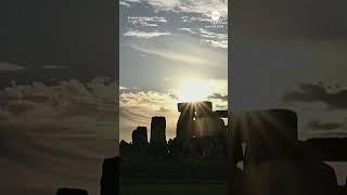 Revelers watch sunset at Stonehenge on summer solstice