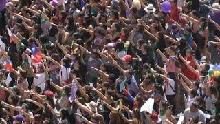 Chileans sign "A Rapist in Your Path" during Women's Day protest | AFP