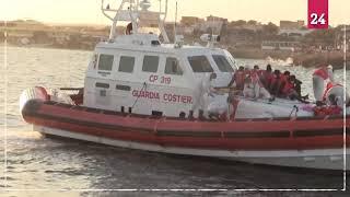 Italian coastguard with migrants from Banksy-funded rescue boat arrives at Lampedusa island