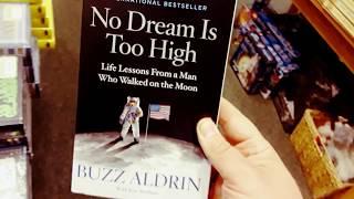 Holding the Book "No Dream is Too High" By Buzz Aldrin, For Sale at Barnes & Noble in Greece Ridge M