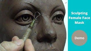 Sculpting female face mask design in a water based clay.