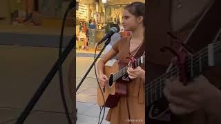 Karolina Protsenko talks to the crowd and plays guitar