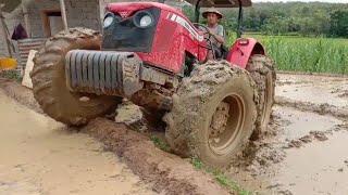 Large 4-wheel tractor stuck in mud hard to ride