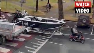 Man pulls huge boat with mobility scooter