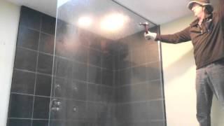Breaking tempered glass shower wall door.