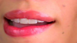 Extreme close up of woman biting lower lip. Stock Footage