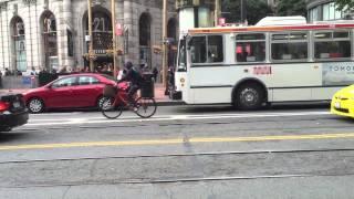 Uber driver blocking Muni bus in San Francisco. Police officer yells at driver