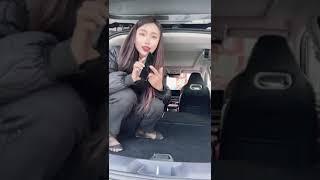 Chinese girl show her black nylon feet in car