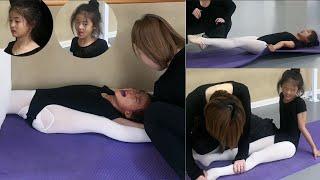 Dance student flexibility training, although crying, still mischievously sticking out their tongue.