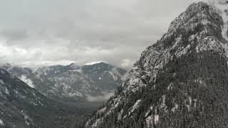 4k Snowy Mountain Peak and Cloudy Valley Aerial Drone View