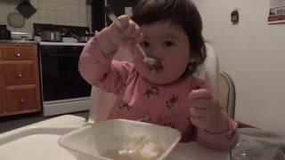 2 years old baby eating by herself with spoon