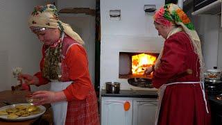 Two UDMURT hostesses preparing a viburnum pie - SHANYAN' in a wood oven. Russian cultures cuisine