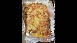 Meat with tomatoes and cheese in an oven