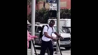 Bronny James rides an electric scooter through USC’s campus 