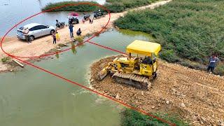 Whole video!! It is impressive that the KOMATSU Dozer crew can even pour stone to create water road