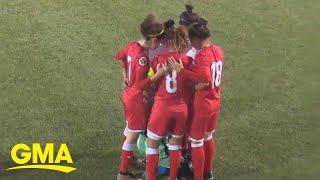 Opponents huddle around soccer player so she can fix her hijab l GMA Digital