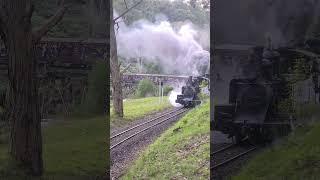 two steam locomotives pull train over trestle bridge