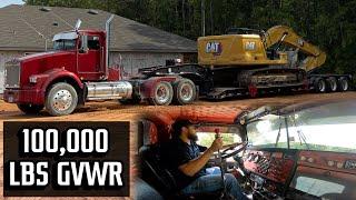 Kenworth HAULING HEAVY trackhoe with a 60 series detroit diesel