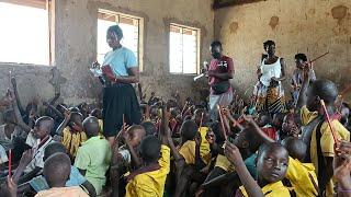 African village girl giving a helping hand to a village school