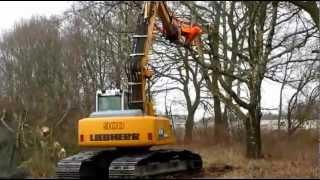 Excavator cutting trees in the woods LIEBHERR 900 clearing land with hydraulic shear