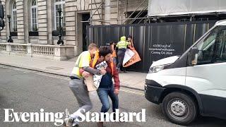 Just Stop Oil protesters scuffle with scaffolders on Pall Mall