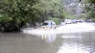 A Jeep goes through water