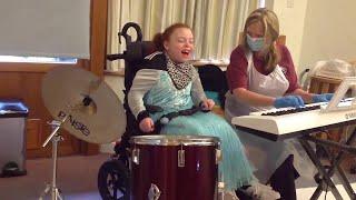 Freya enjoying music therapy with Ceridwen at Little Bridge House