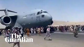 Afghans climb on to plane during takeoff in attempt to flee Taliban