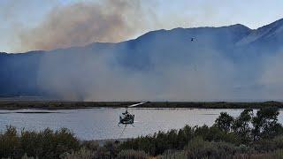 Multiple helicopters fighting fire