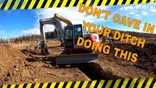 How to Jump off a trench with your excavator with out caving in your ditch.