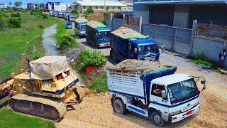 Processing a large landfill with a Komatsu D58E bulldozer, pushing soil by 5ton dump trucks.Mix 2VDO