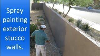 Spray painting exterior stucco walls.