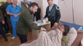 Volodymyr Zelensky visits family hit by Russian shelling