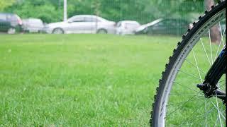 bicycle wheel in the park on green grass panning footage